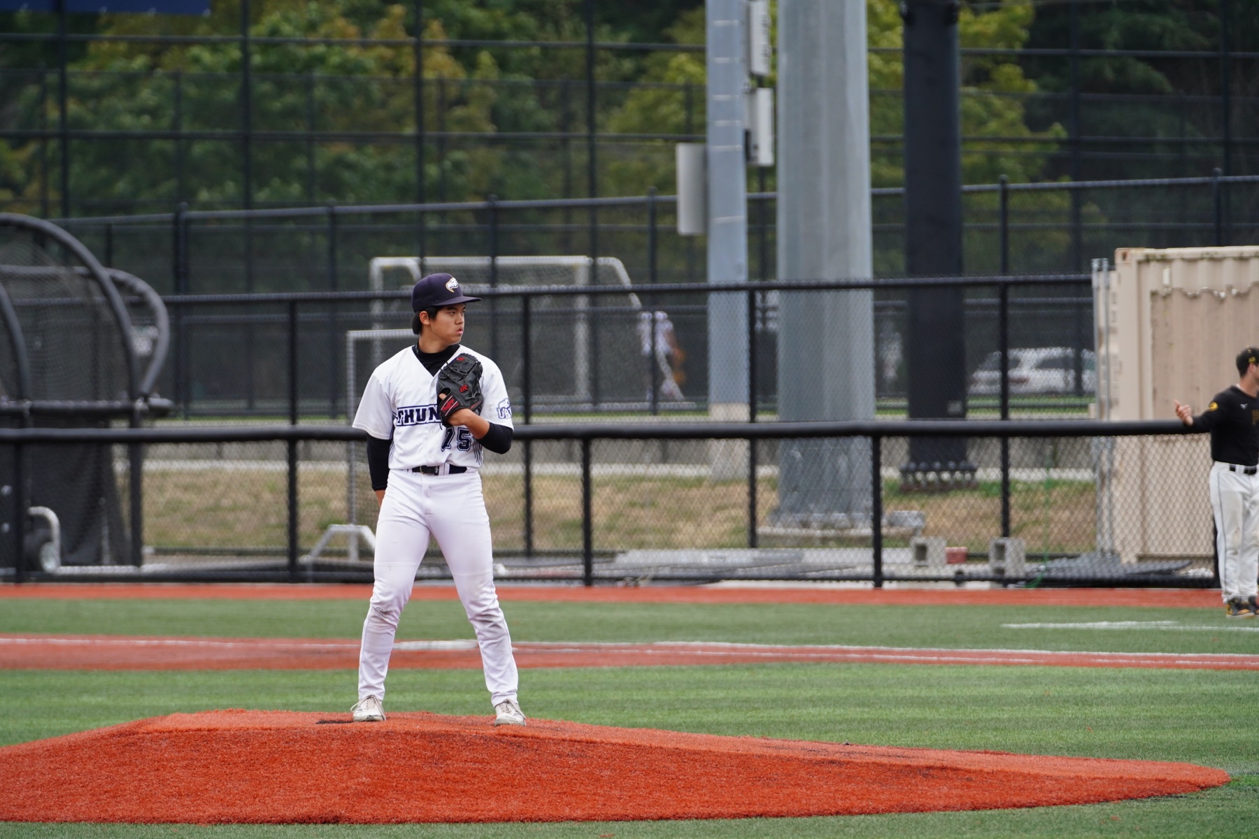 Christopher standing on a baseball pitching mound in a UBC Thunder uniform before delivering a pitch.